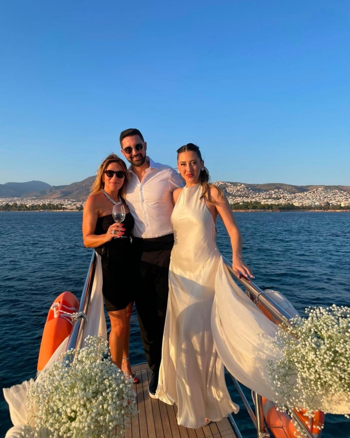 The couple on the bow in the late afternoon, gypsophila at their feet, with Maria who planned the day