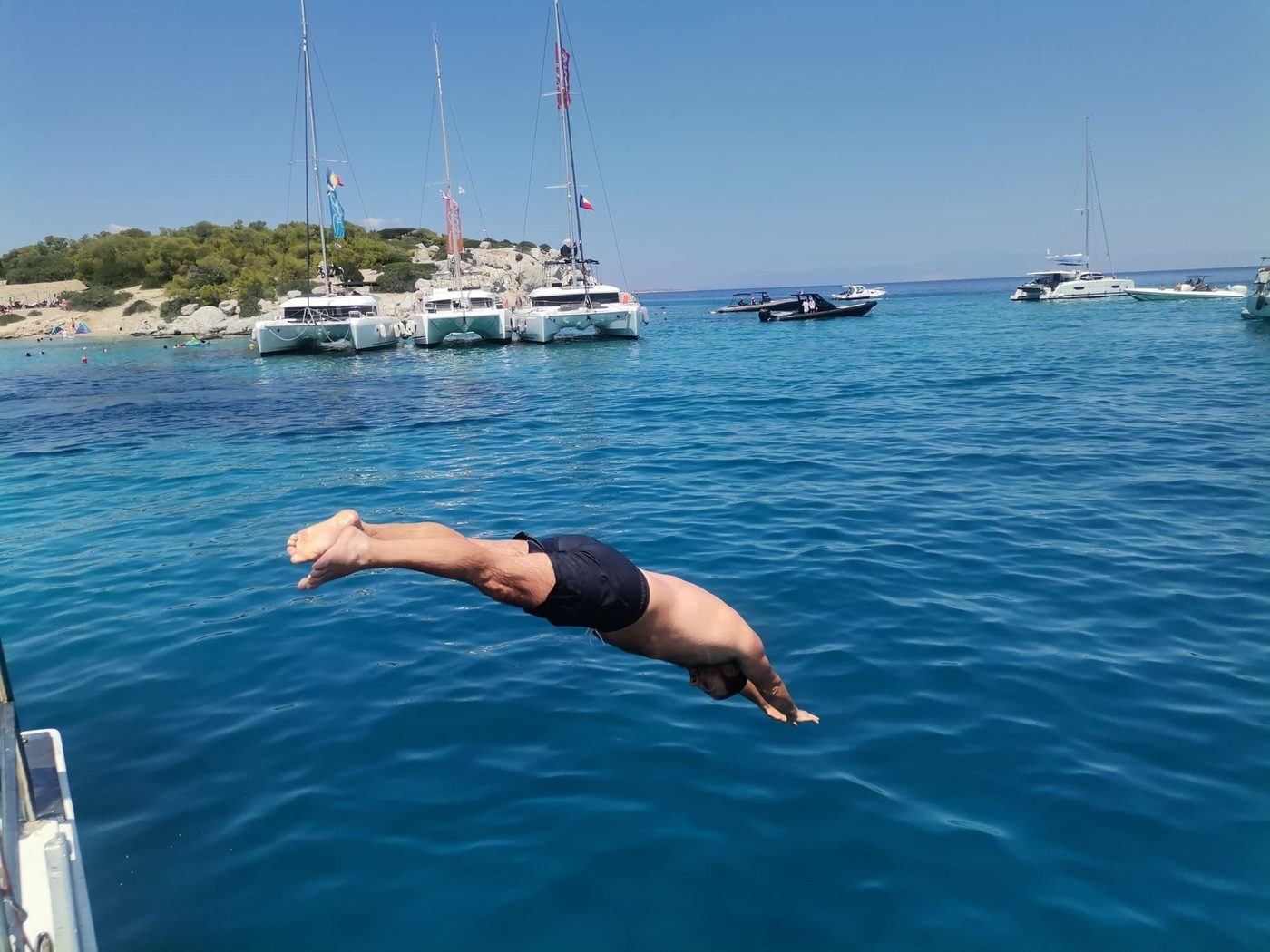 A guest diving from the boat